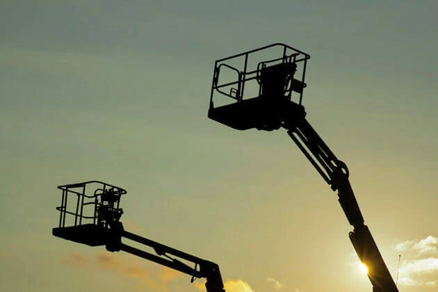 Cherry pickers at sunset