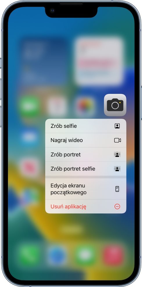 Rozmazany ekran początkowy; pod ikoną aplikacji Aparat wyświetlane jest menu szybkich czynności.