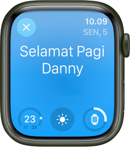 Apple Watch menampilkan layar bangun. Kata Selamat Pagi muncul di bagian atas. Level baterai terdapat di bawah.