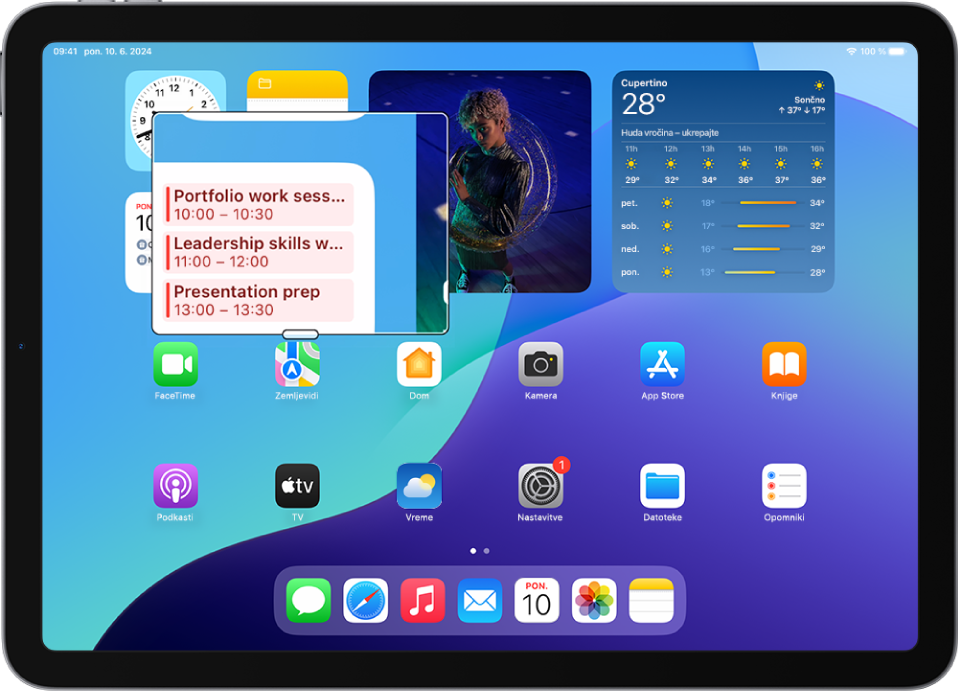 iPad, ki prikazuje domači zaslon z oknom, povečanim na delu zaslona.