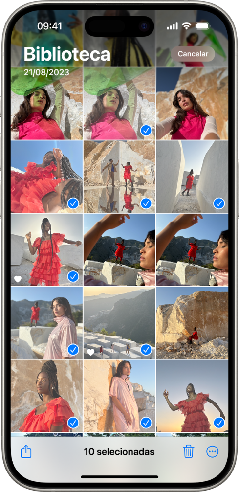 O ecrã do iPhone está preenchido com uma grelha de fotografias, algumas das quais estão selecionadas. Na parte inferior do ecrã estão os botões “Partilhar”, “Apagar” e “Mais”.