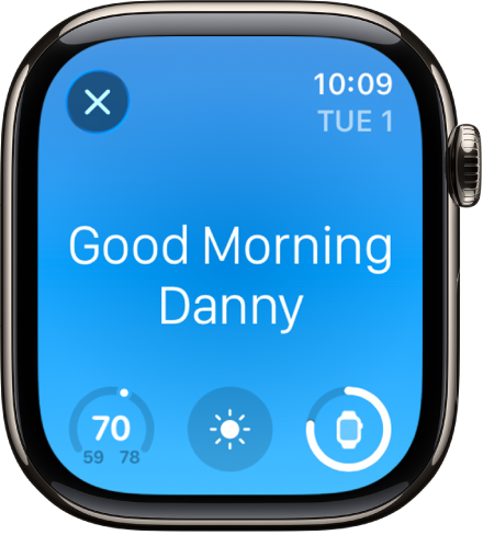 Apple Watch showing the wake up screen. The words Good Morning appear at the top. The temperature, weather condition, and battery level are below.