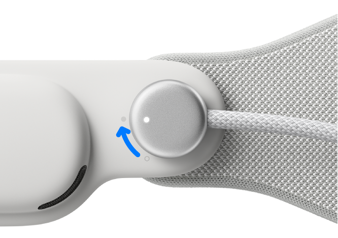 Apple Vision Pro with the power cable attached to the left Audio Strap. An arrow is showing the clockwise rotation of the power cable.