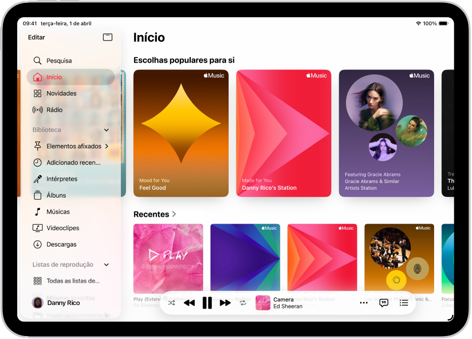 O separador Início na aplicação Música com a barra lateral à esquerda e a secção Início à direita. O separador Início mostra escolhas populares na parte superior. A música reproduzida recentemente aparece por baixo e mostra quatro capas de álbuns. O minileitor está na parte inferior.