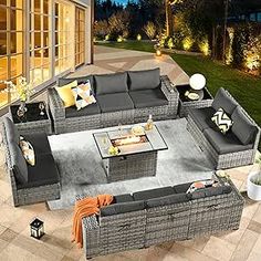 an outdoor living room with grey wicker furniture