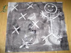 a child's drawing on a piece of paper that has been placed on the floor
