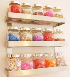 a shelf filled with lots of different colored sprinkles
