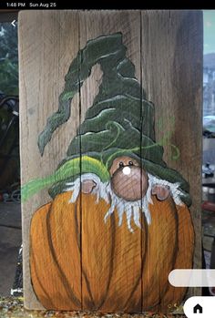 a painted wooden post with a pumpkin on it