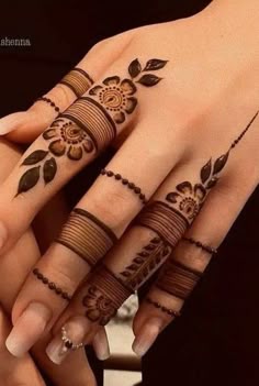 Simple lines and dots henna on fingers with some flowers