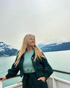 a woman standing on the deck of a boat