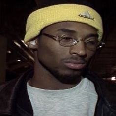 a man wearing glasses and a yellow hat