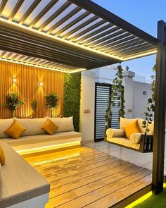 an outdoor living area with couches and lights