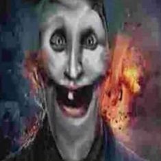 a man wearing a creepy mask with fire coming out of his mouth