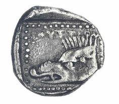 an ancient coin with the head of a lion on it's face and two heads in