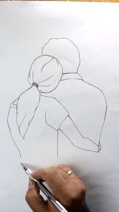 someone is drawing a woman's head on paper