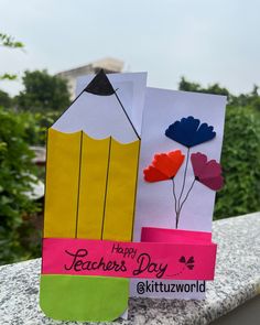 two paper bags with flowers and pencils on them, one is for teachers day