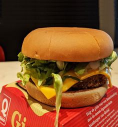 a cheeseburger sitting on top of a box