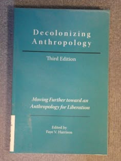 a book on decolonizing anthroplogy sitting on a carpeted floor