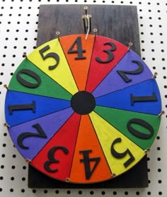 a colorful wooden clock with numbers on it