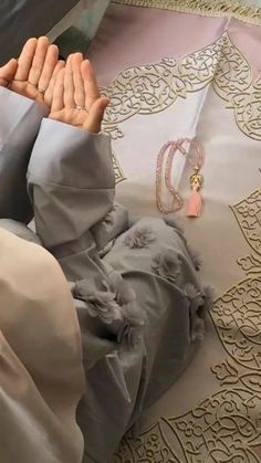 a person laying on the ground with their hands together