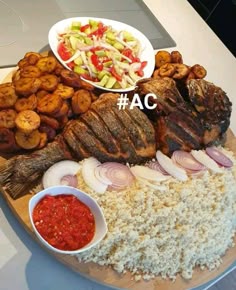 a platter with meat, rice and vegetables on it next to a bowl of sauce