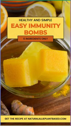 a bowl filled with sliced up lemons on top of a wooden table next to orange slices