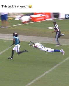 a football player is diving to catch the ball