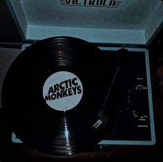 an old record player with the arctic monkeys on it's turntable in a box