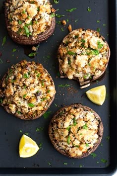 baked mushrooms with cheese and herbs on a baking sheet