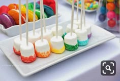 there are many colorful candies on the plate