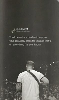 a man holding a tennis racquet standing in front of a crowd with a quote on it