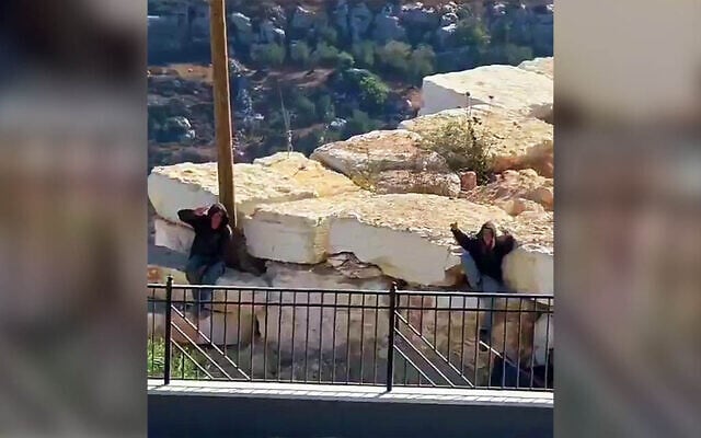 Settlers gesture to the camera as they remain outside the besieged homes of Palestinian residents in Qusra, near Nablus in the northern West Bank, August 13, 2026 (Video screenshot; used in accordance with Clause 27a of the Copyright Law) Settlers gesture to the camera as they remain outside the besieged homes of Palestinian residents in Qusra, near Nablus in the northern West Bank, August 13, 2026 (Video screenshot; used in accordance with Clause 27a of the Copyright Law)