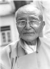 An old man wearing spectacles.