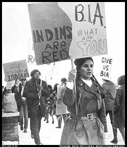 A group of NIYC demonstrators holding signs in front of the BIA office.