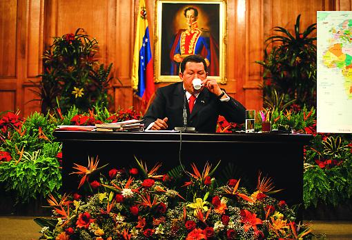 Hugo Chávez sitting in the shadow of Bolívar, pausing during a press conference. Portrait: Andrew Cutraro Hugo Chávez sitting in the shadow of Bolívar. Portrait: Andrew Cutraro