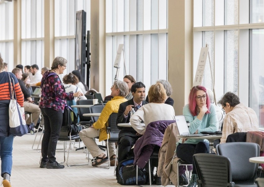 People chatting between presentations at the math meeting