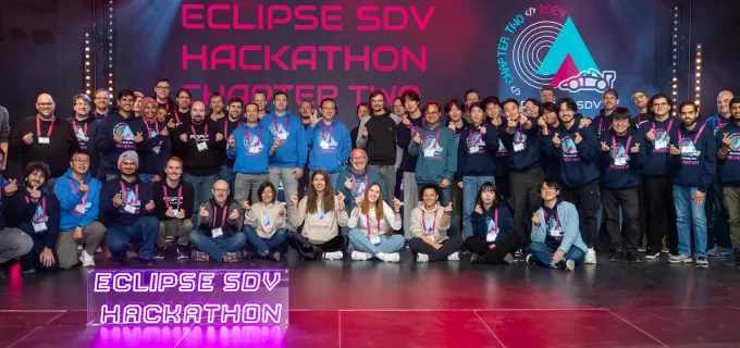 A group photo of participants at the Eclipse Software Defined Vehicle Hackathon, showcasing a diverse group of developers and enthusiasts gathered together.